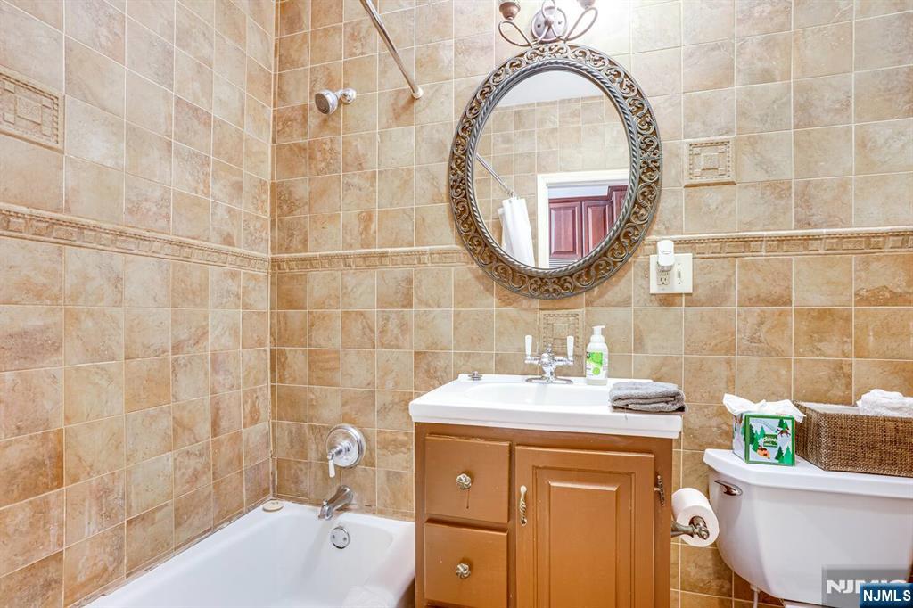 608 Madison Street, Unit 2 Hoboken, NJ 07030 - Photo 12 of 24 a bathroom with a sink a mirror and a bathtub