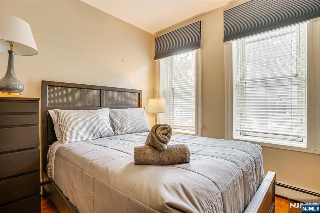 608 Madison Street, Unit 2 Hoboken, NJ 07030 - Photo 13 of 24 a bedroom with a bed and window