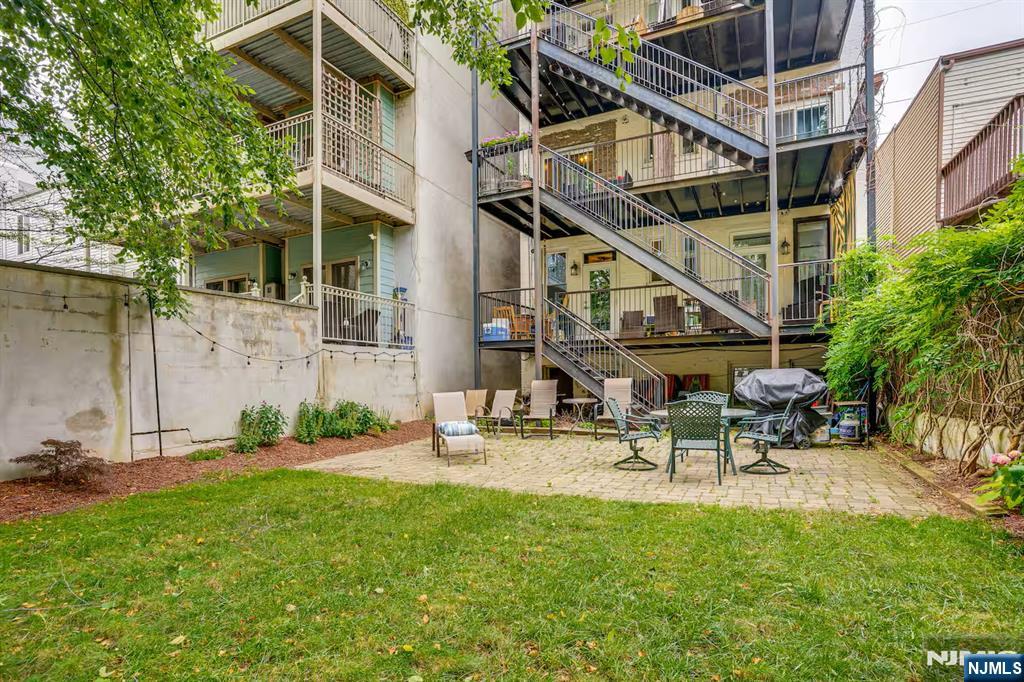 608 Madison Street, Unit 2 Hoboken, NJ 07030 - Photo 18 of 24 a view of a chair and table in backyard of the house