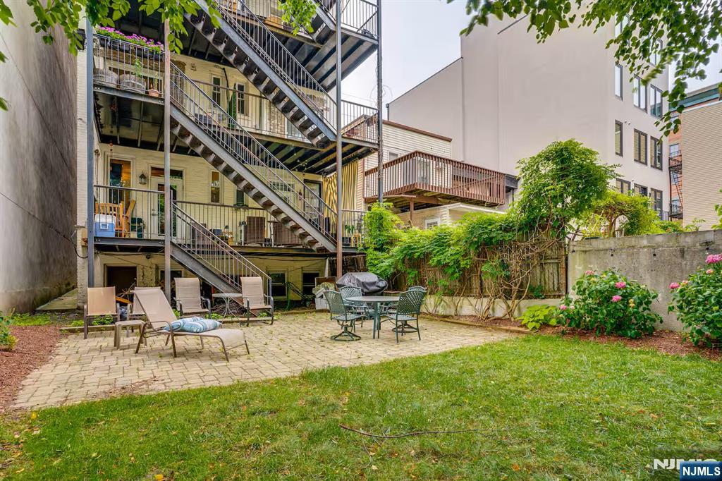 608 Madison Street, Unit 2 Hoboken, NJ 07030 - Photo 21 of 24 a view of a building with backyard and sitting area