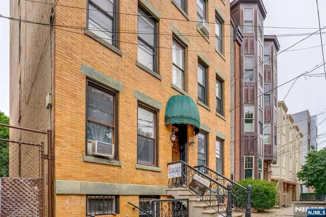 a brick house with large windows