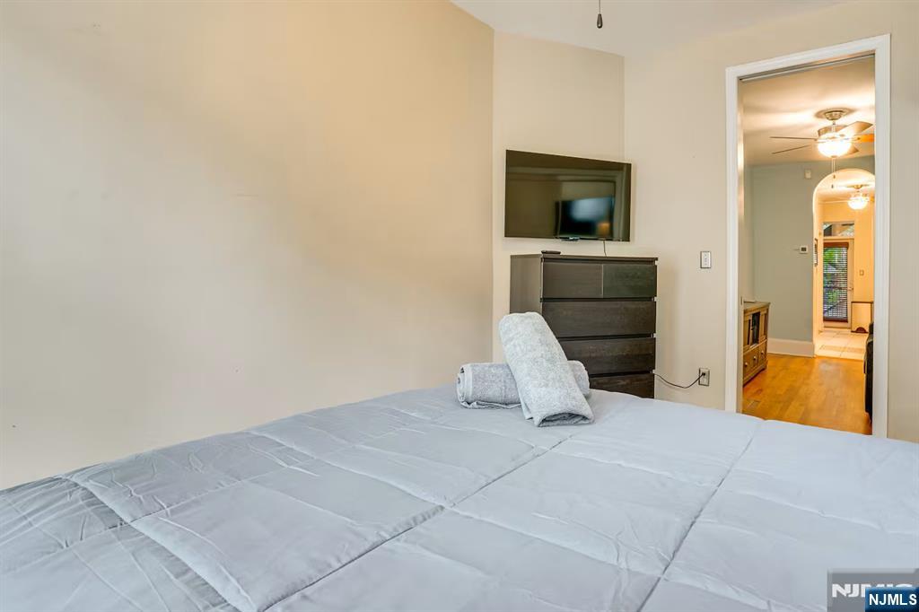 608 Madison Street, Unit 2 Hoboken, NJ 07030 - Photo 10 of 24 a view of a livingroom with wooden floor and a flat screen tv