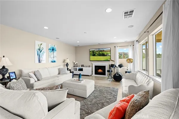 a living room with furniture and a fireplace