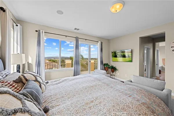 a bedroom with a large bed and a large window
