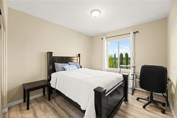 a bedroom with a bed chair and a window