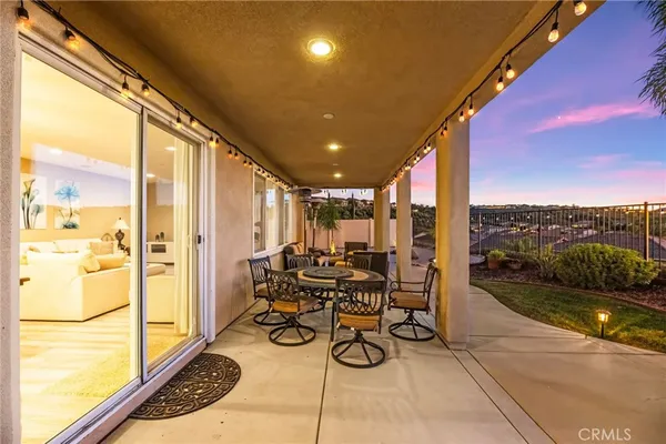 a view of a patio with couches and table and chairs