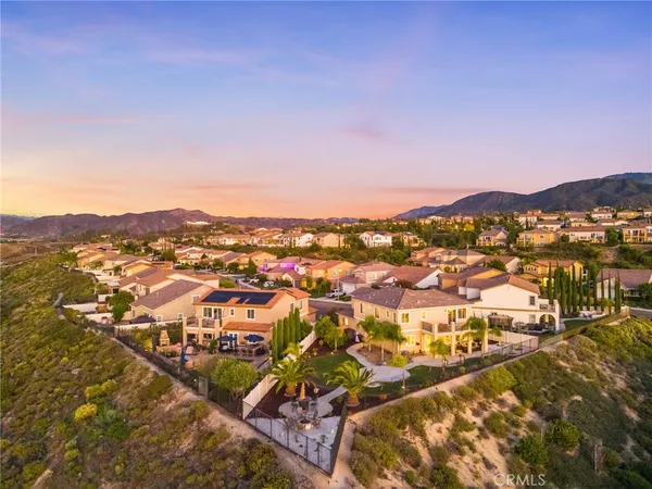 an aerial view of residential houses with city view
