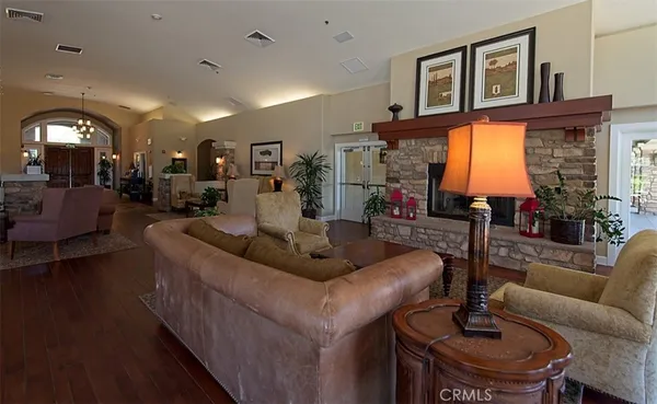 a living room with furniture wooden floor and a large window