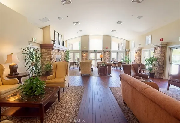 a view of a patio with a table chairs and a floor to ceiling window