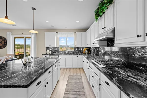a large kitchen with granite countertop a lot of counter space