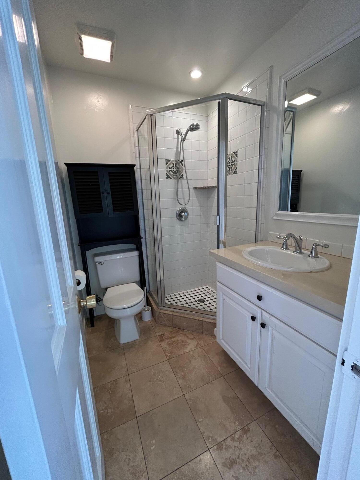 810 East Canon Perdido Street, Unit A Santa Barbara, CA 93103 - Photo 6 of 12 a bathroom with a double vanity sink toilet and shower