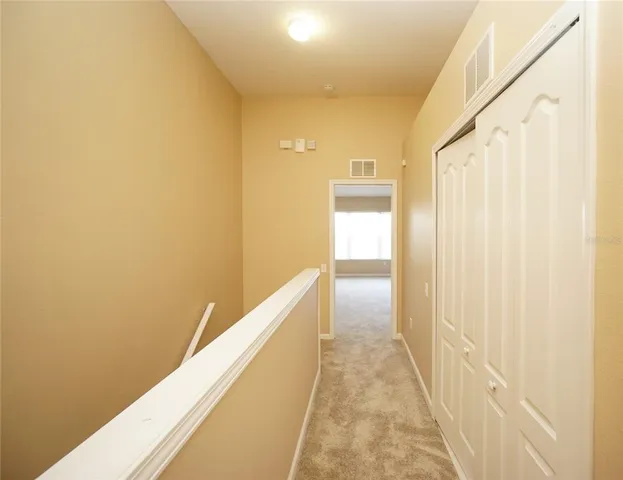 a view of a hallway with wooden shelves