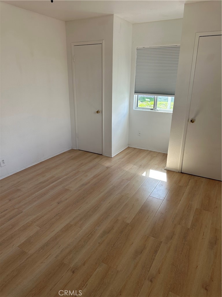 1380 Indian Sage Road Lancaster, CA 93534 - Photo 12 of 24 an empty room with wooden floor and windows