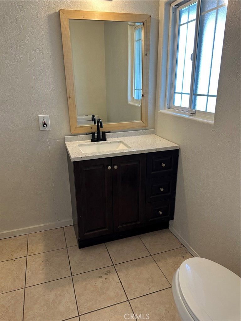 1380 Indian Sage Road Lancaster, CA 93534 - Photo 15 of 24 a bathroom with a sink vanity and toilet