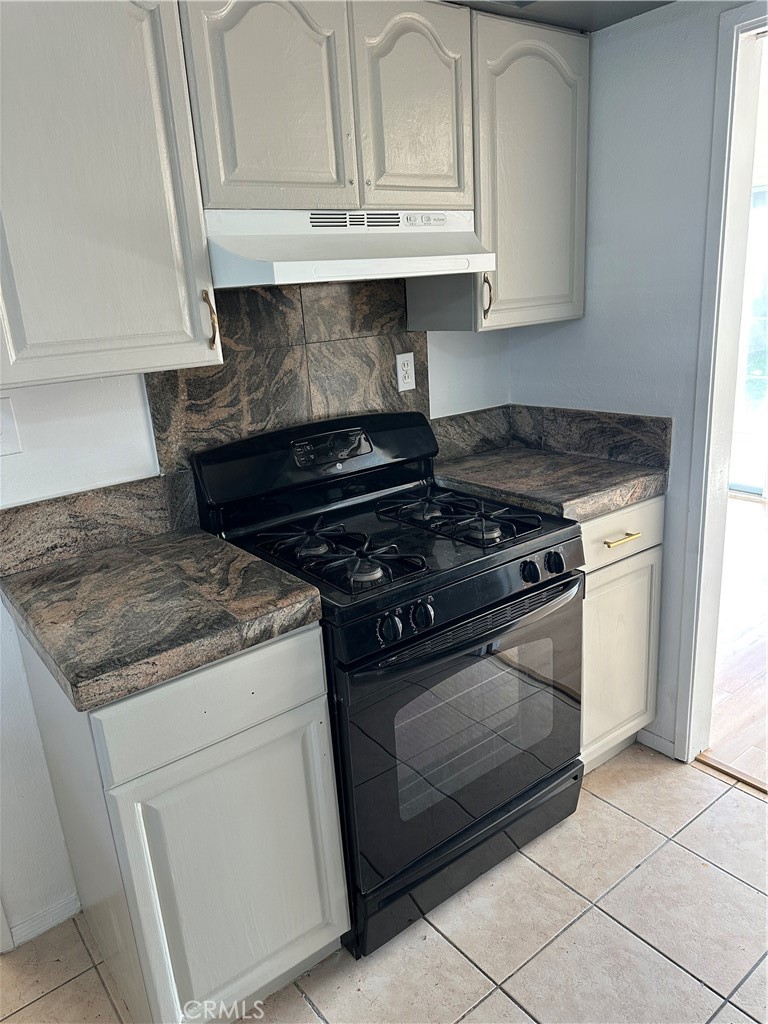 1380 Indian Sage Road Lancaster, CA 93534 - Photo 17 of 24 a stove top oven sitting inside of a kitchen