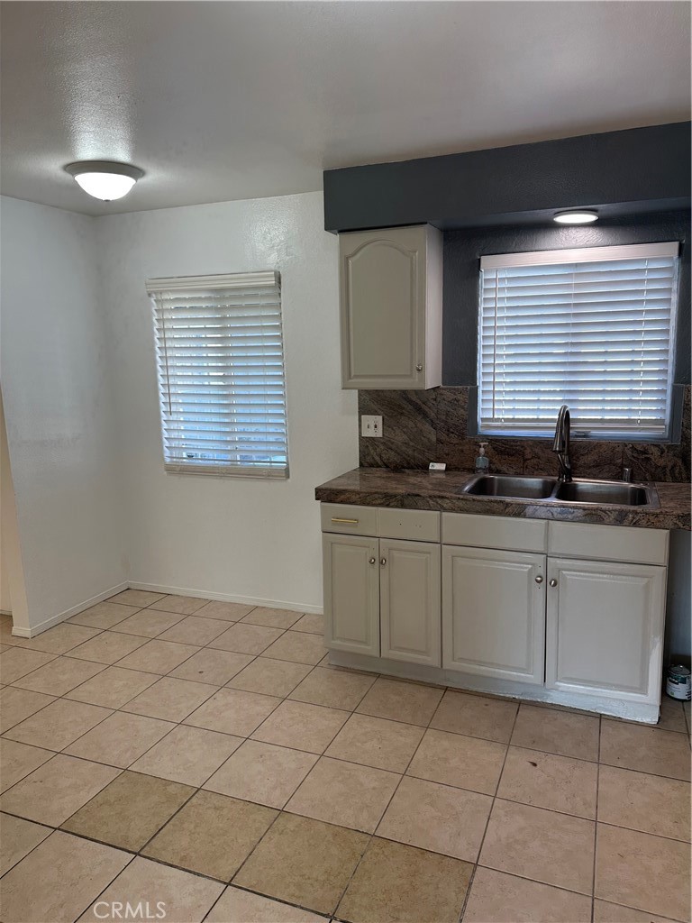 1380 Indian Sage Road Lancaster, CA 93534 - Photo 21 of 24 a kitchen with a sink and cabinets