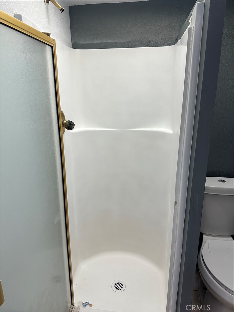 1380 Indian Sage Road Lancaster, CA 93534 - Photo 22 of 24 a bathroom with a shower and toilet