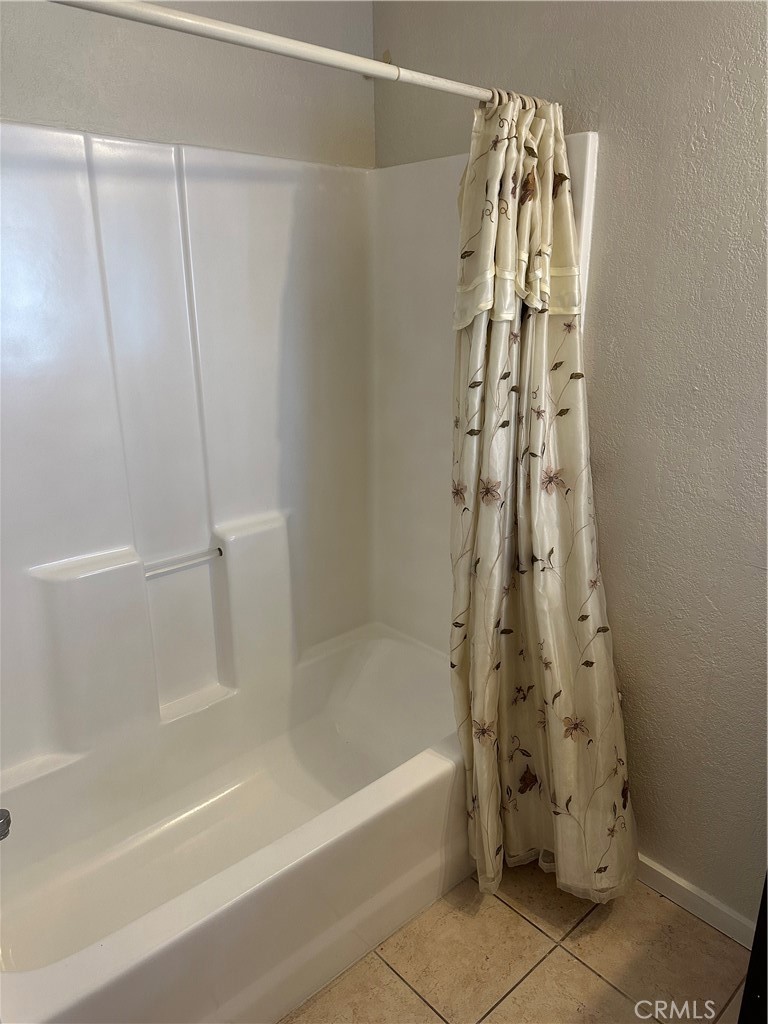 1380 Indian Sage Road Lancaster, CA 93534 - Photo 24 of 24 a bathroom with a bathtub and shower