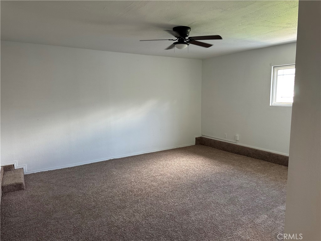 1380 Indian Sage Road Lancaster, CA 93534 - Photo 7 of 24 a view of a livingroom with a ceiling fan and window