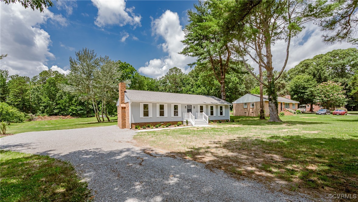 4300 North Courthouse Road Providence Forge, VA 23140 - Photo 5 of 28 a front view of a house with a yard and trees