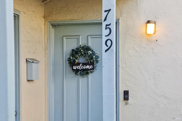 a view of a room that has a bed and a mirror in it