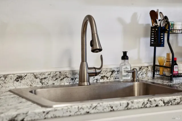 a kitchen with stainless steel appliances kitchen island a white stove top oven and sink