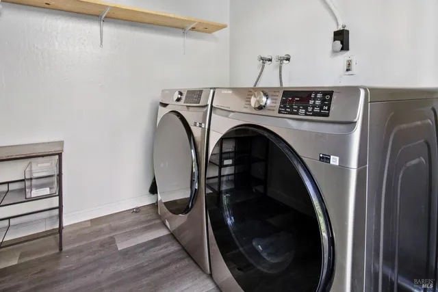 a patio with wooden floor a yard tables and chairs