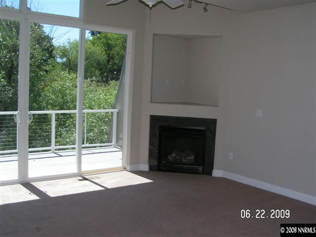 1950 Dickerson Road Reno, NV 89503 - Photo 3 of 7 a living room with a fireplace and a floor to ceiling window