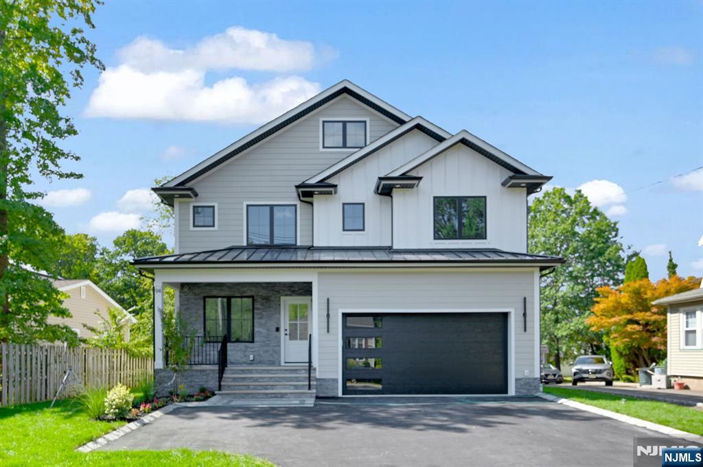 a front view of a house with a garden and garage