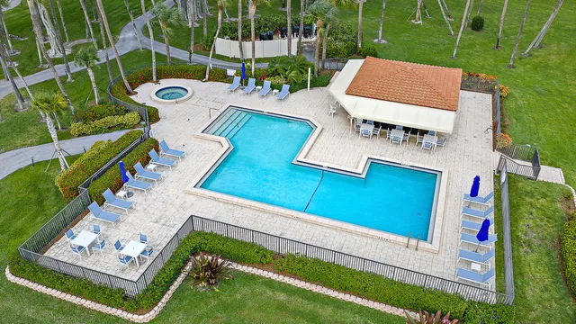 a dining room with furniture and large windows