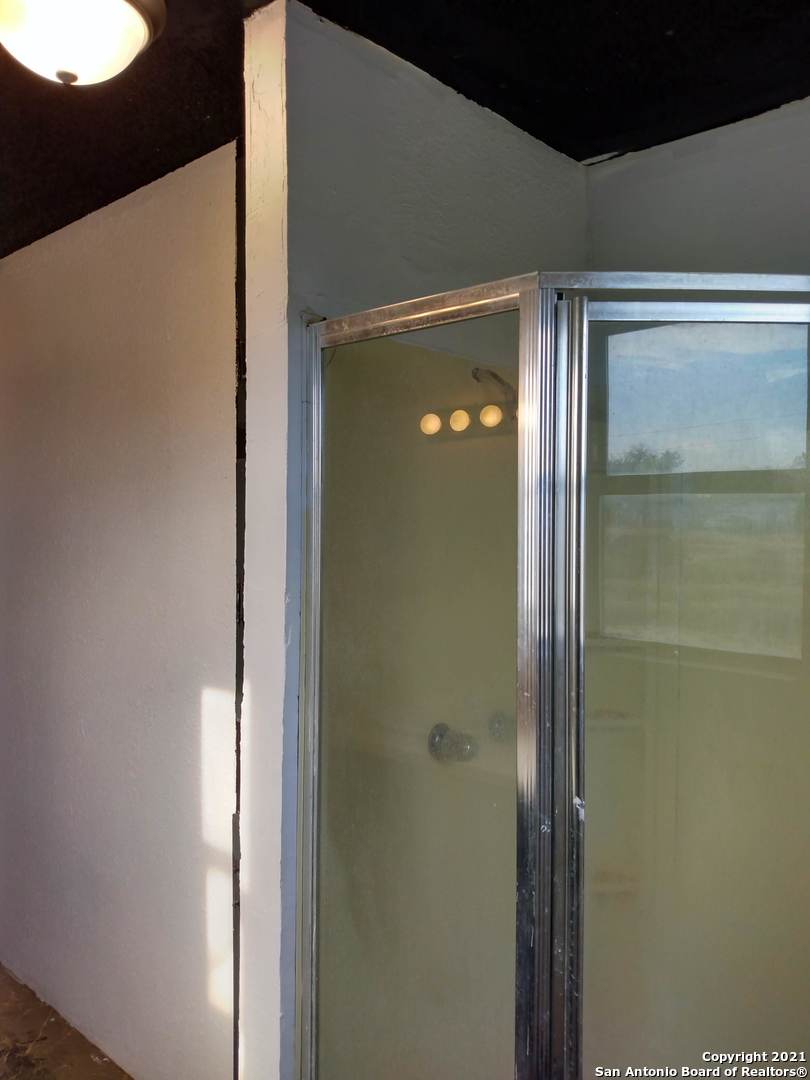 818 Austin Street Asherton, TX 78827 - Photo 15 of 15 a bathroom with a shower