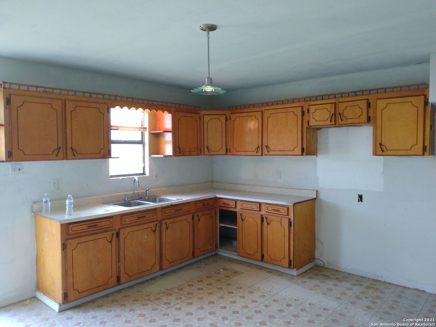 818 Austin Street Asherton, TX 78827 - Photo 10 of 15 a kitchen with sink cabinets and window