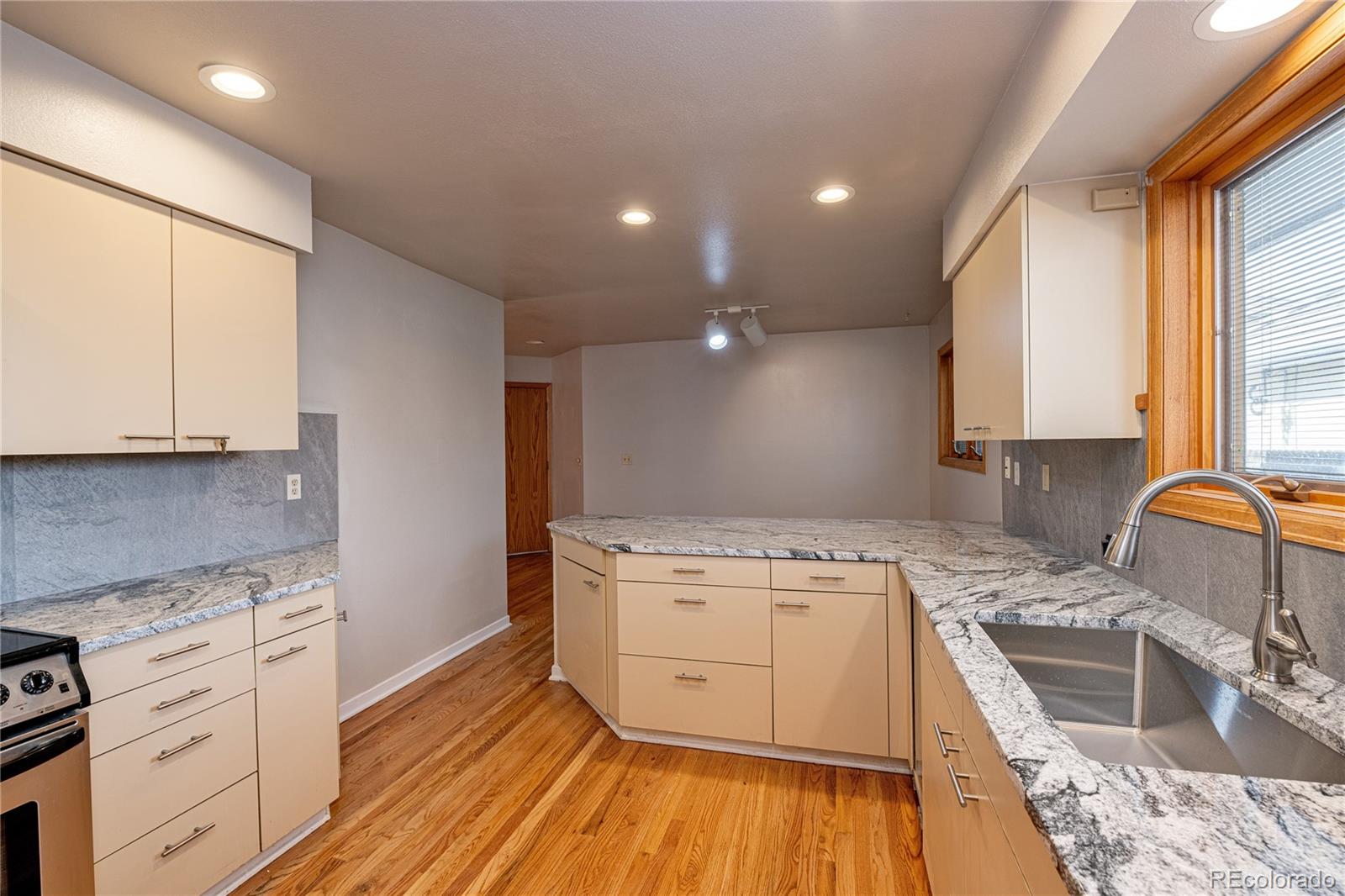 541 Monroe Street, Unit B Denver, CO 80206 - Photo 17 of 37 a kitchen with a stove a sink and a refrigerator