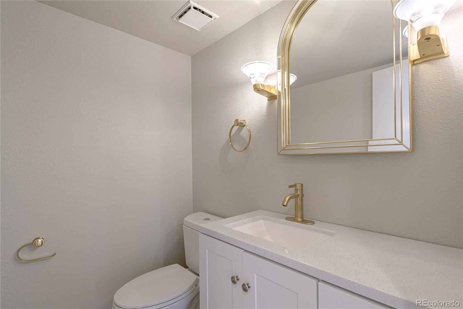 541 Monroe Street, Unit B Denver, CO 80206 - Photo 20 of 37 a bathroom with a toilet sink and mirror