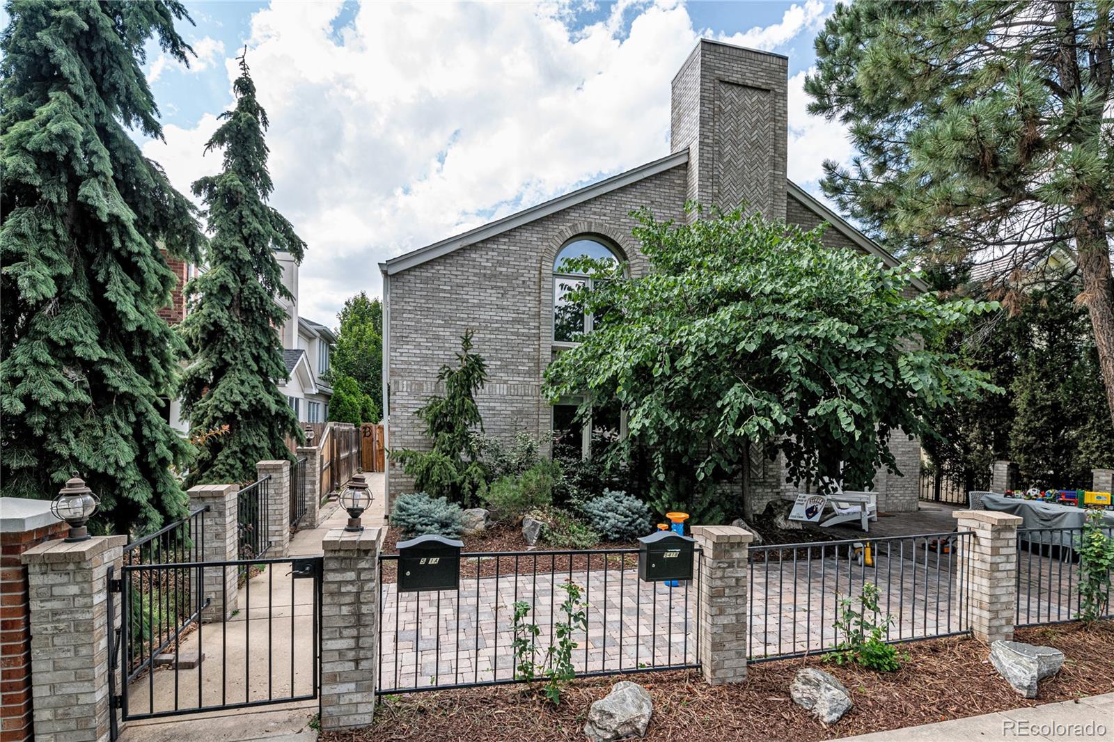 541 Monroe Street, Unit B Denver, CO 80206 - Photo 2 of 37 a front view of a house with a garden