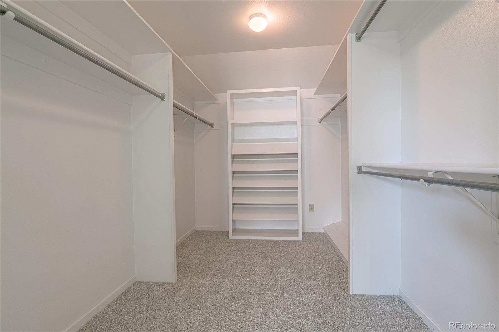 541 Monroe Street, Unit B Denver, CO 80206 - Photo 23 of 37 a view of walk in closet with empty racks