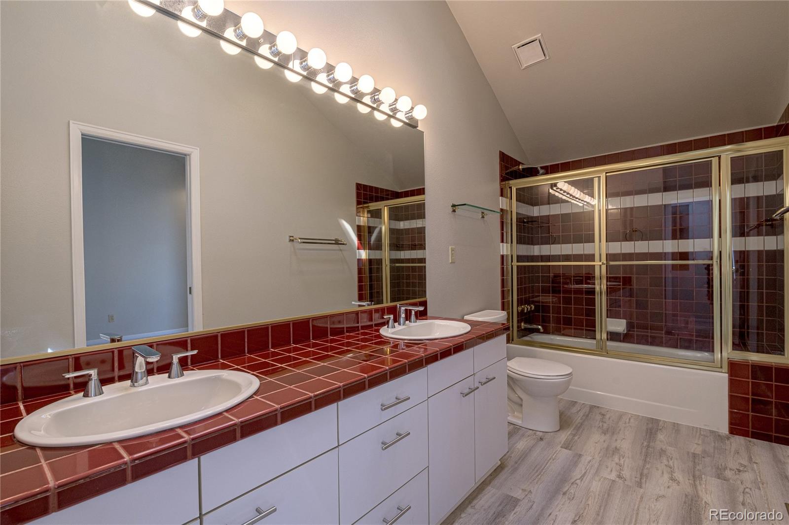 541 Monroe Street, Unit B Denver, CO 80206 - Photo 30 of 37 a spacious bathroom with a granite countertop sink mirror and shower