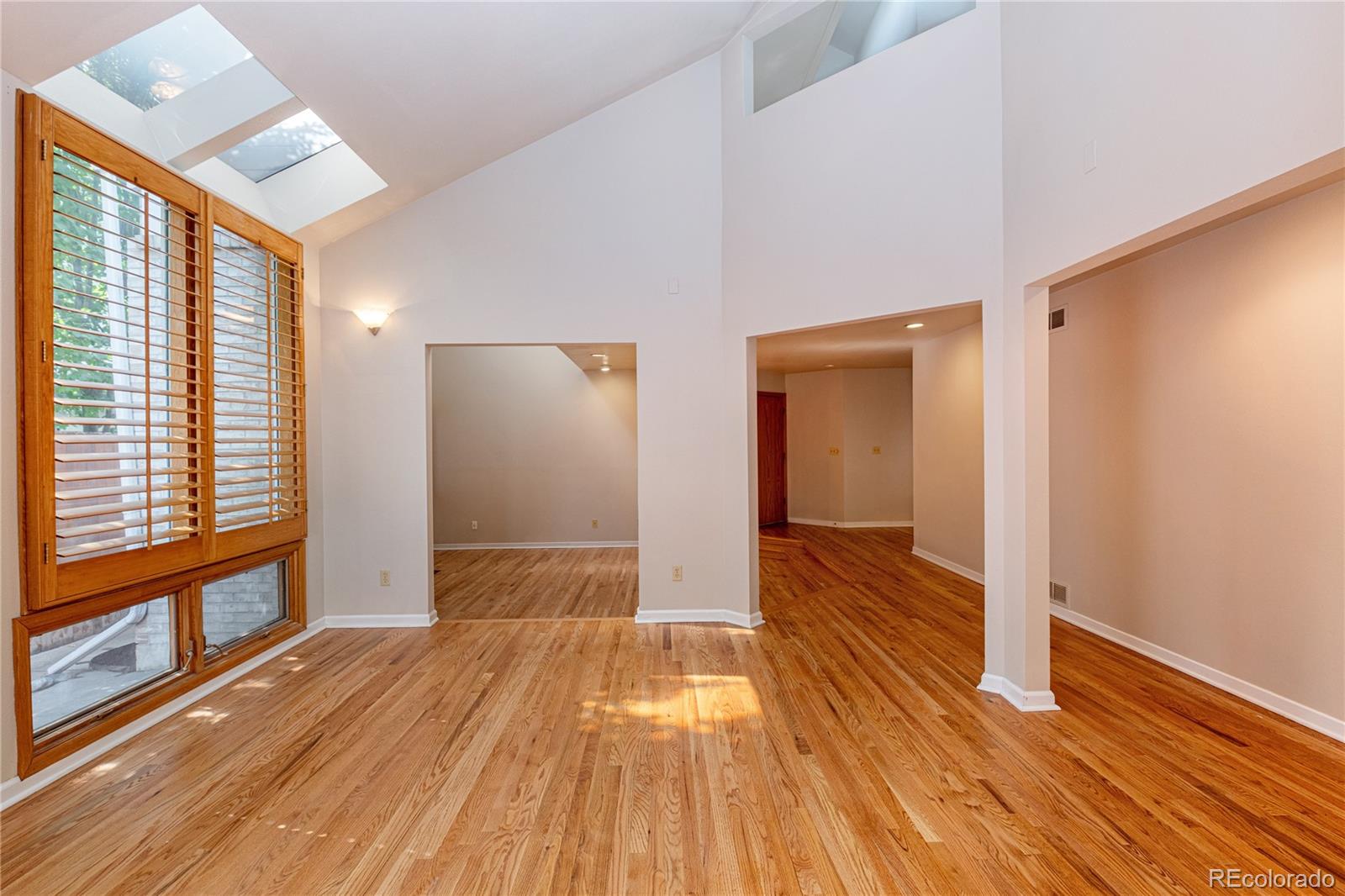 541 Monroe Street, Unit B Denver, CO 80206 - Photo 7 of 37 a view of a room with wooden floor and doors
