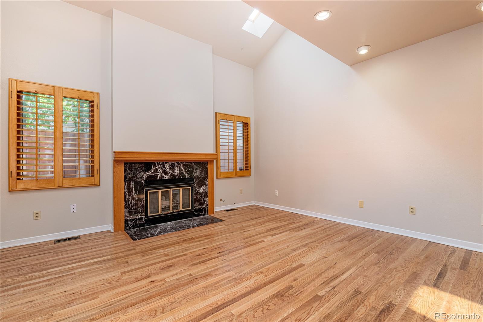 541 Monroe Street, Unit B Denver, CO 80206 - Photo 10 of 37 an empty room with wooden floor fire place and windows