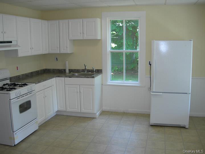 3 Center Street Deposit, NY 13754 - Photo 32 of 45 a kitchen with granite countertop white cabinets and white appliances