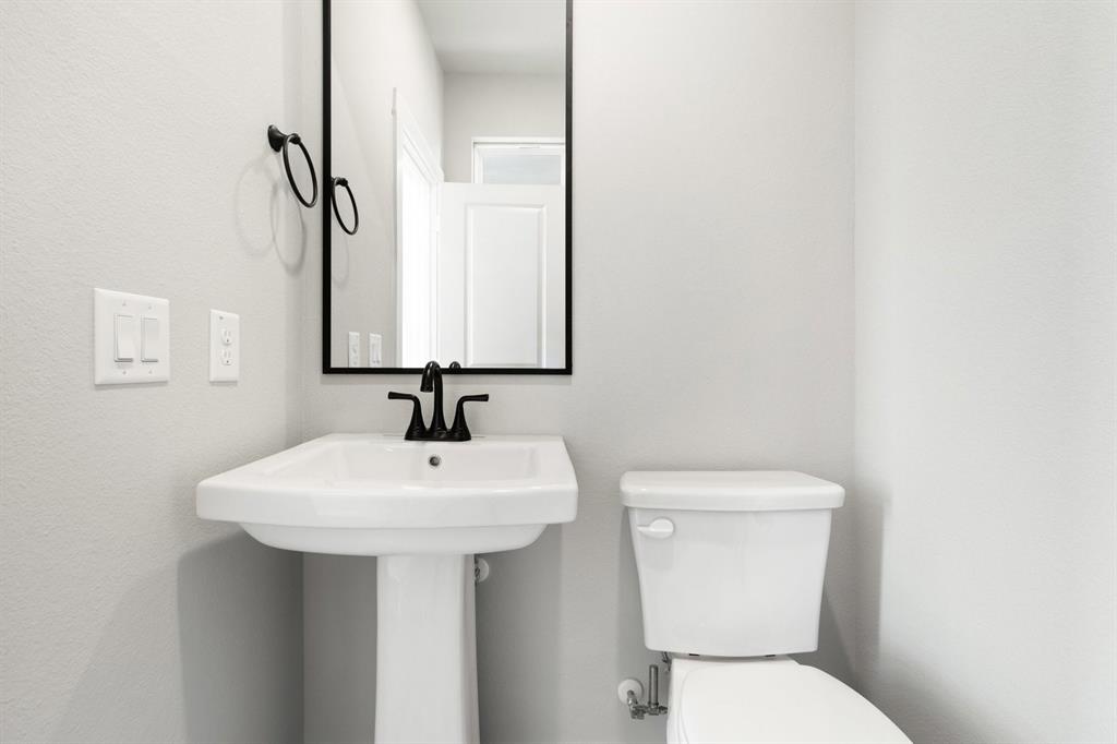 2020 Aldrich Road Celina, TX 75009 - Photo 37 of 40 a bathroom with a sink a toilet and mirror