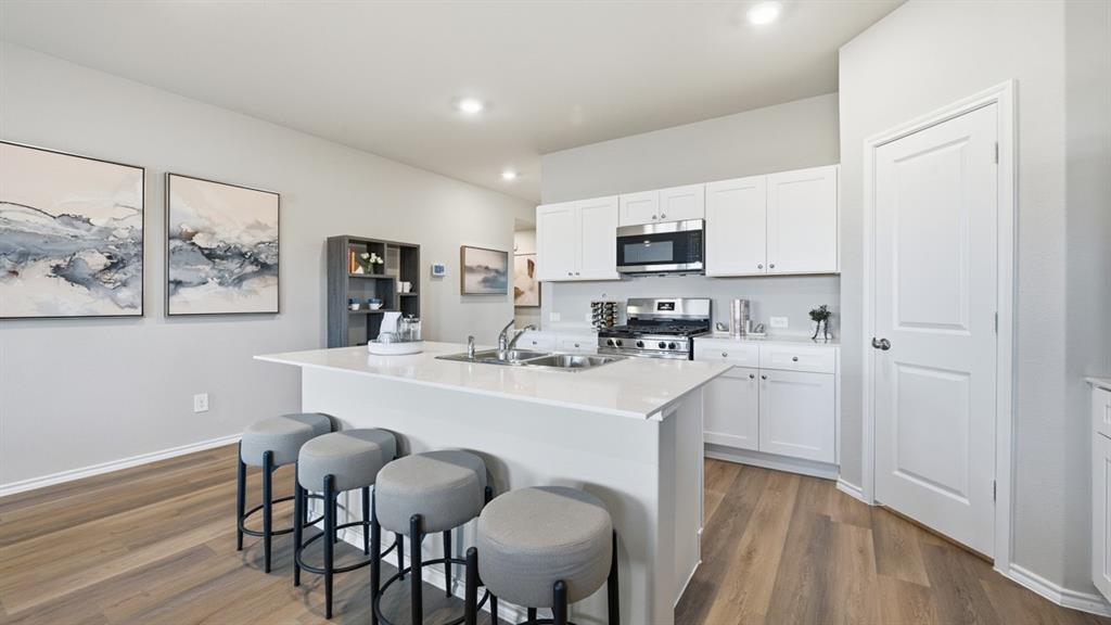 141 MLM Parkway Bridgeport, TX 76426 - Photo 1 of 35 a kitchen with kitchen island a stove a table and chairs in it