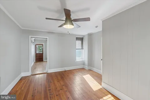 wooden floor in an empty room with a window