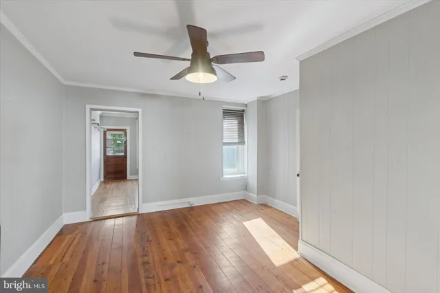 wooden floor in an empty room with a window