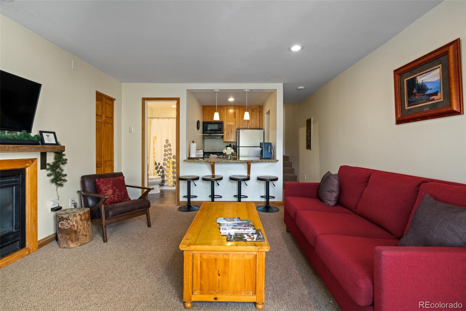 1800 Burgess Creek Road, Unit 205 Steamboat Springs, CO 80487 - Photo 13 of 28 a living room with furniture and a flat screen tv
