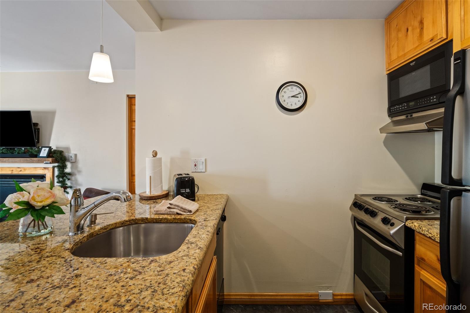 1800 Burgess Creek Road, Unit 205 Steamboat Springs, CO 80487 - Photo 16 of 28 a kitchen with a sink and a stove top oven