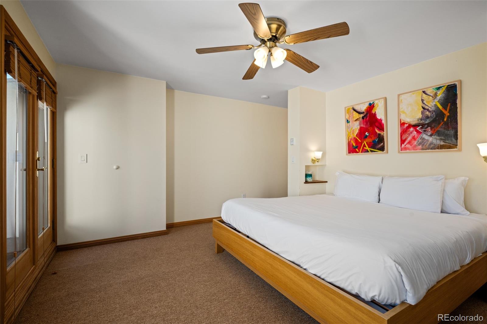1800 Burgess Creek Road, Unit 205 Steamboat Springs, CO 80487 - Photo 23 of 28 a bedroom with a bed and a painting on the wall