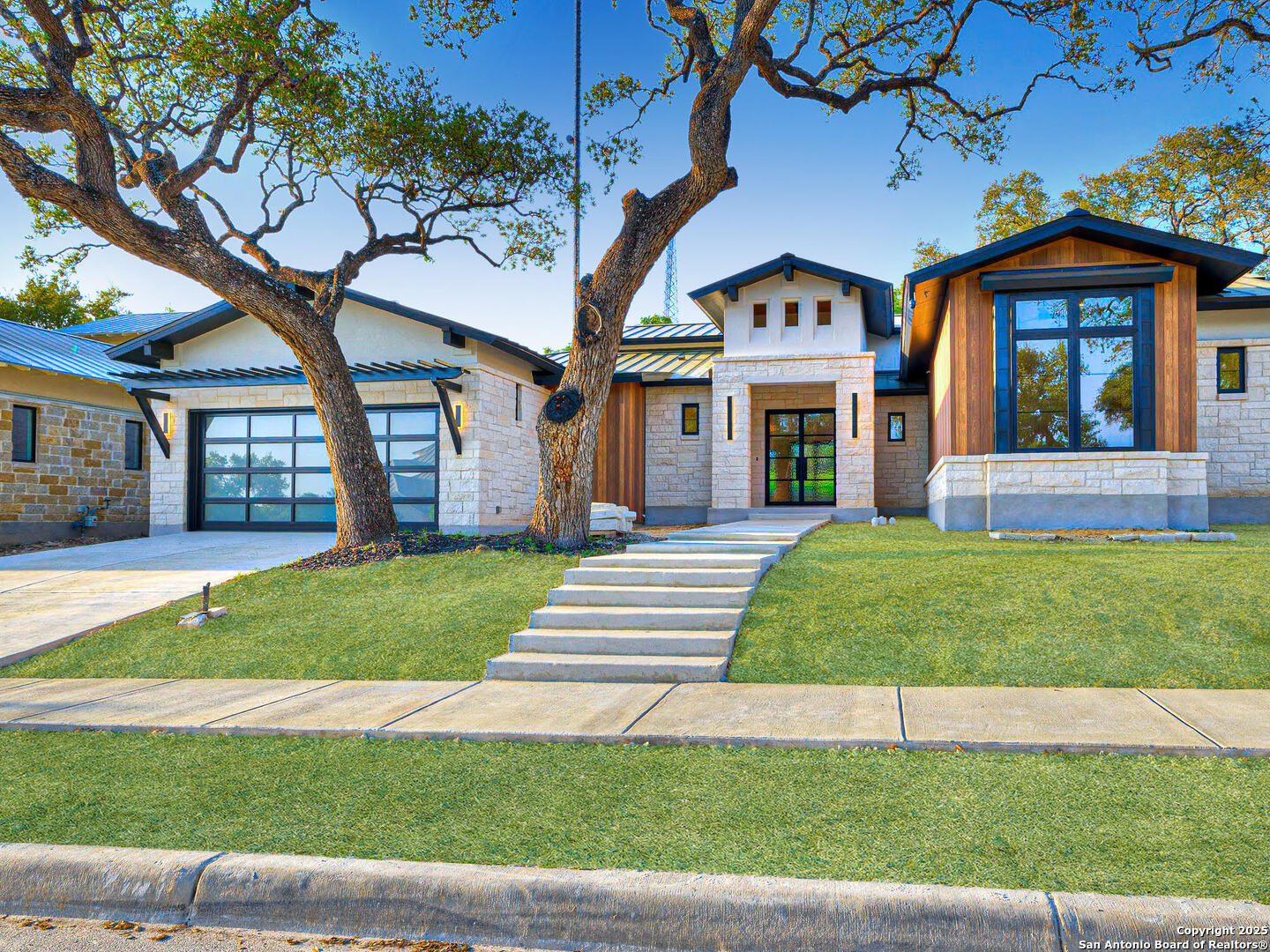 a front view of a house with a garden and yard