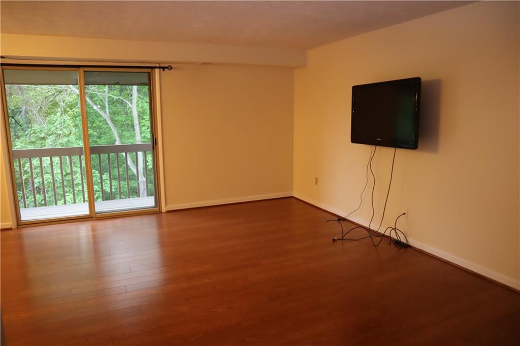 329 Ridge Point Circle, Unit 34 Bridgeville, PA 15017 - Photo 3 of 18 a view of empty room with wooden floor and fan