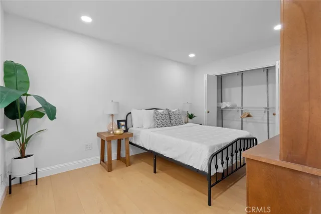 a bedroom with a bed and a large window